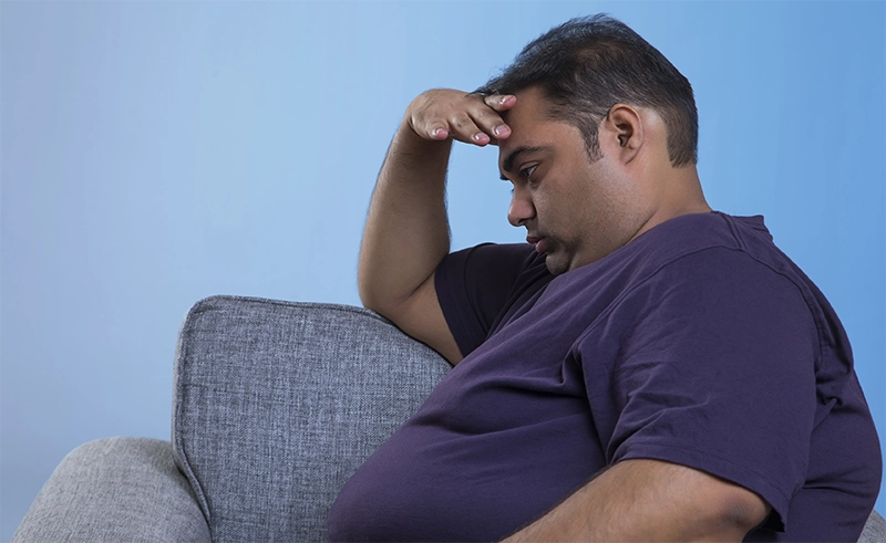 sad man sitting on couch